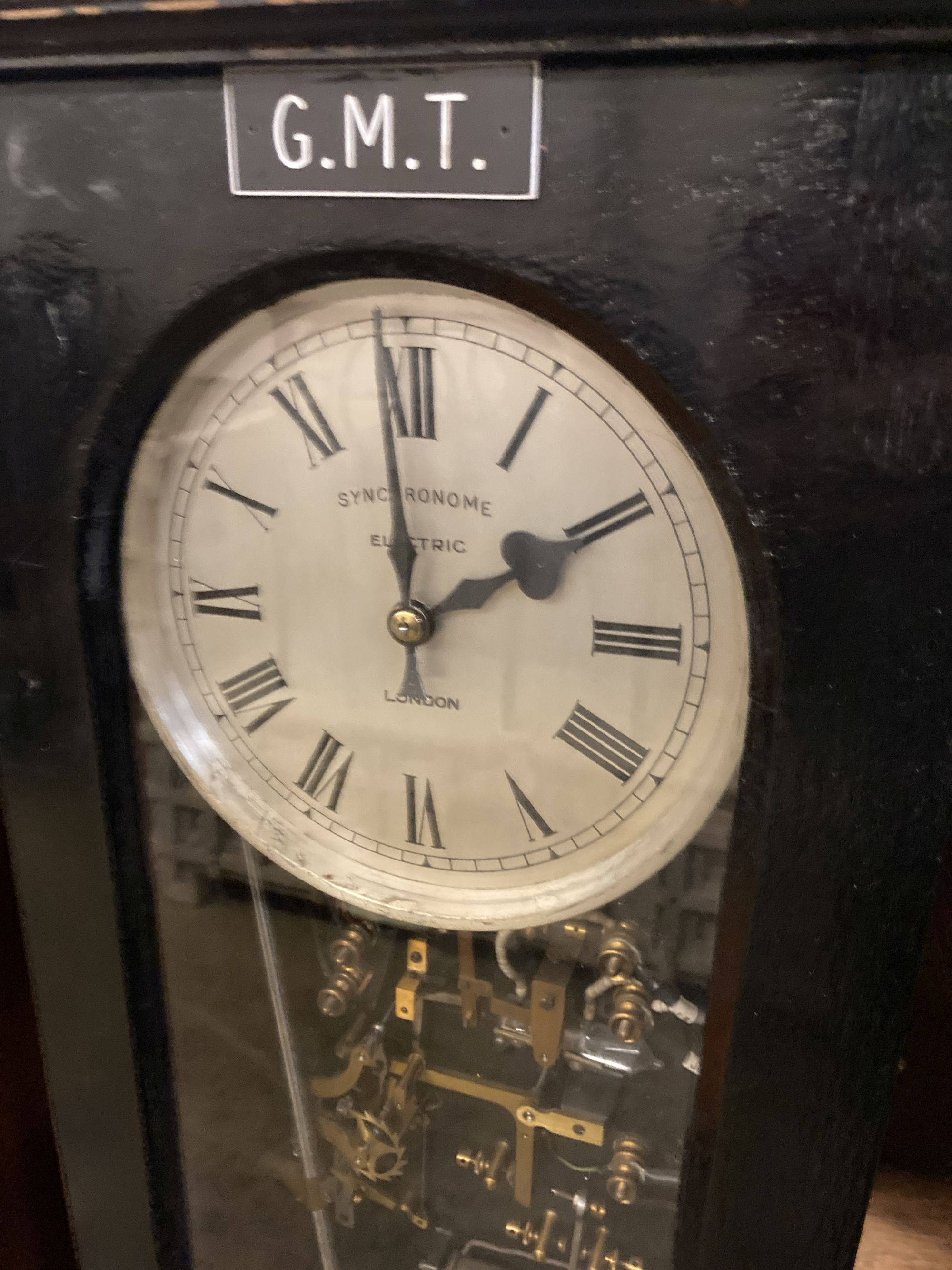 A Synchronome electric oak cased pendulum master clock, height 128cm and a Synchronome electric painted metal circular slave clock